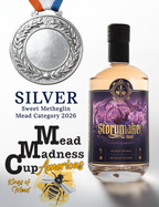 A bottle of Storymaker Mead with a purple label is shown next to a silver medal and award text reading 'Silver Sweet Metheglin Mead Category 2026' and 'Mead Madness Cup Americas' with 'Kings of Mead' branding.